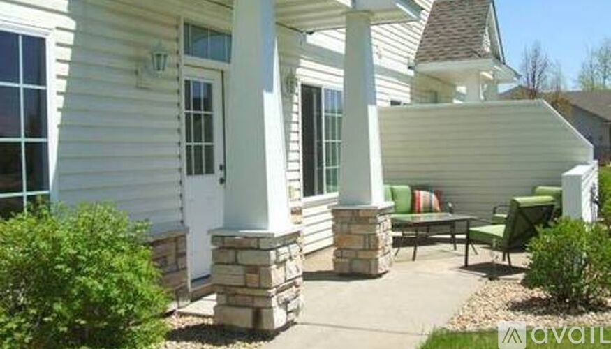 A house with a white porch and a green couch.