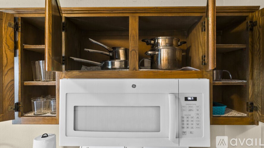 A white microwave oven is sitting on a countertop.