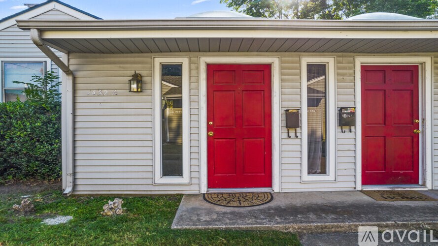 A house with a red door and a sign that says "available".