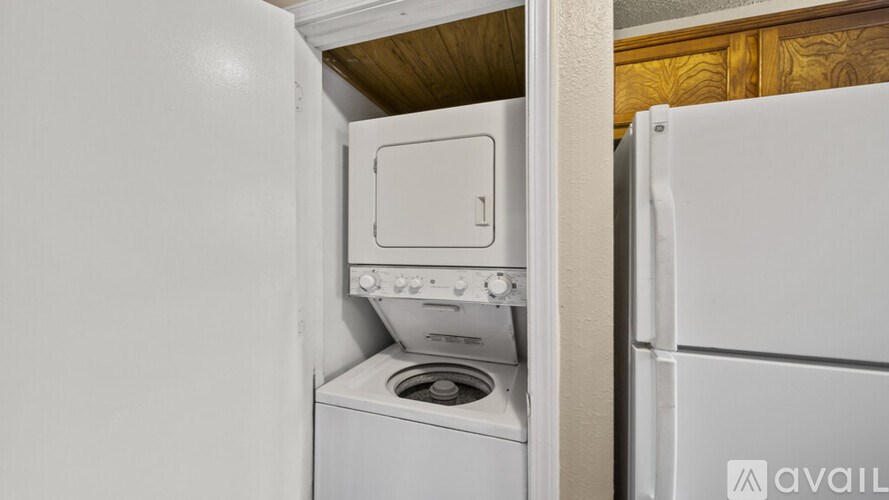 A white oven and stove are built into a kitchen cabinet.