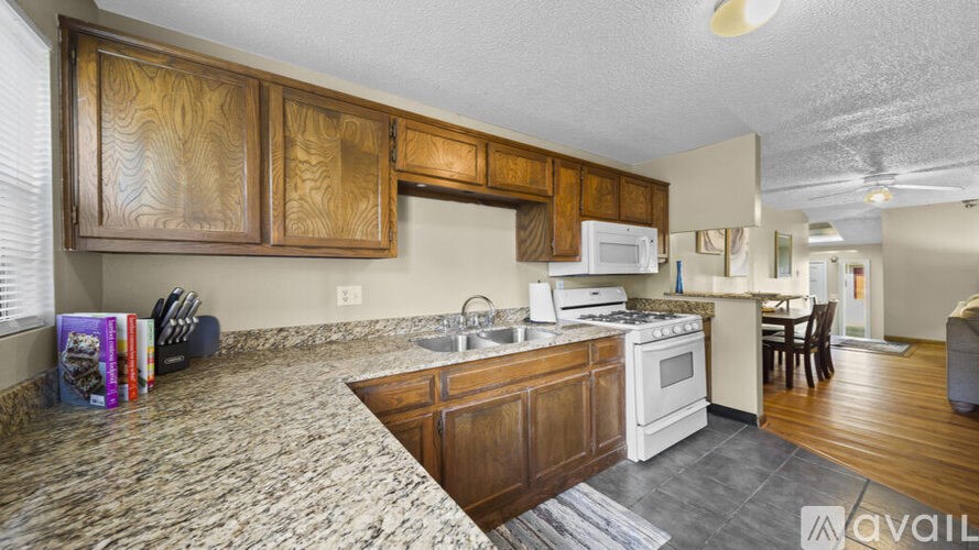 A kitchen with wooden cabinets and a granite countertop.