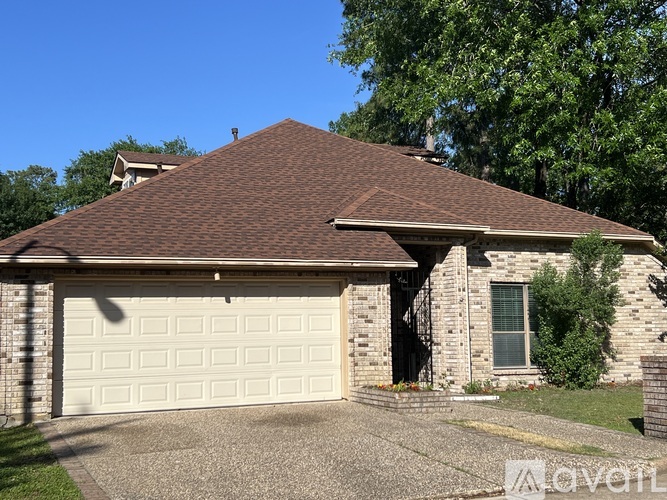 A house with a brown roof and a white garage door.