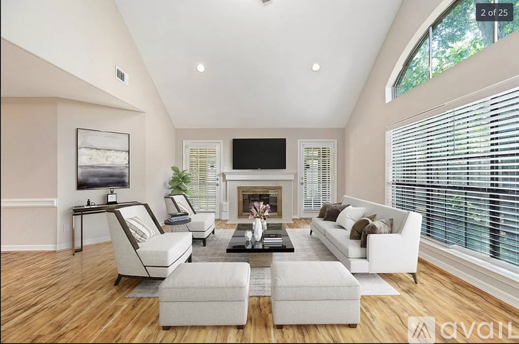 A modern living room with a fireplace and a large window.