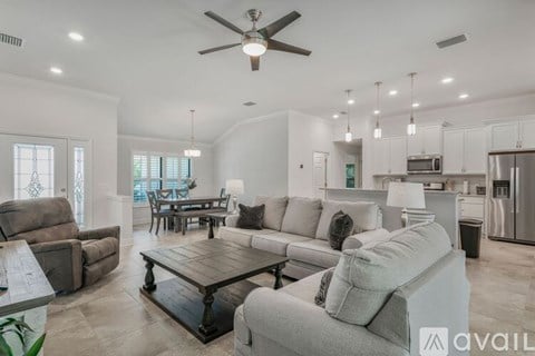 A modern living room with a wooden coffee table and a ceiling fan.