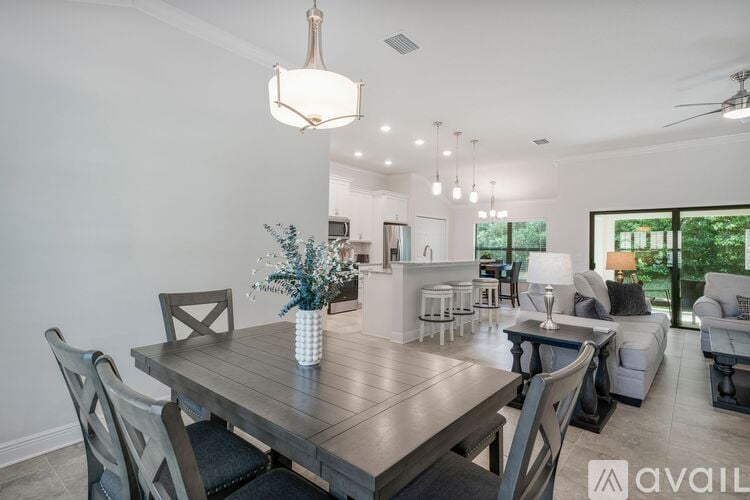 A modern dining room with a wooden table and chairs.