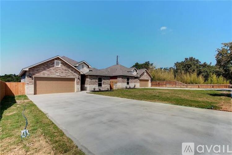 A house with a driveway and garage is available for sale.