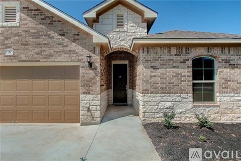 A house with a brown garage door is for sale.