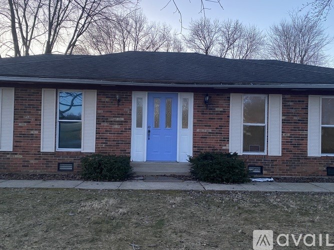 A house with a blue door and white sash windows.