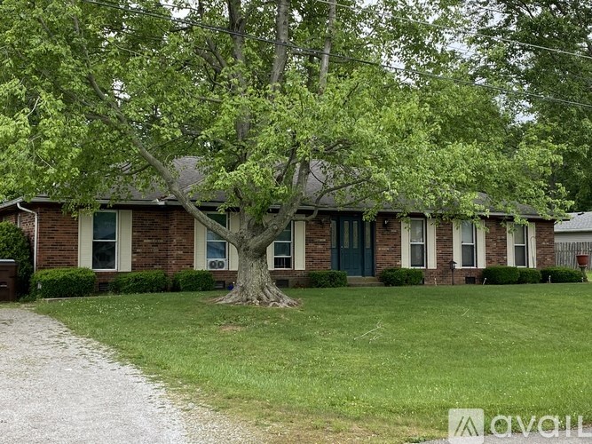 A house with a tree in front of it.
