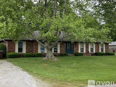 A house with a tree in front of it.
