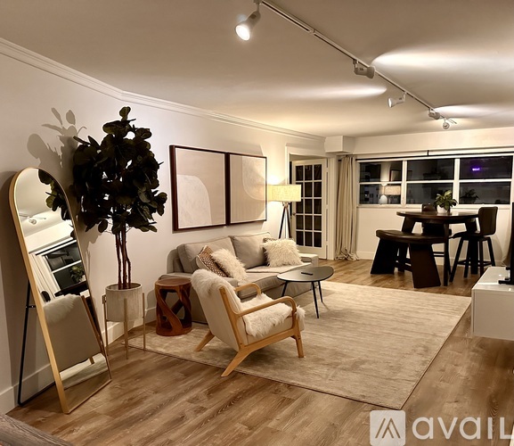 A living room with a wooden floor and furniture.