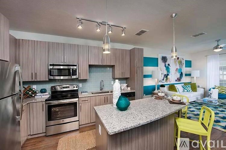A kitchen with a refrigerator, oven, and sink.