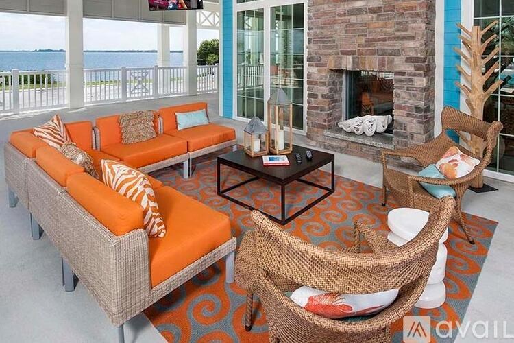 A living room with a sofa, chair, and a fireplace.