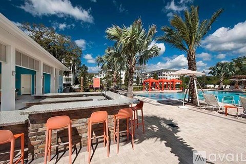 A poolside area with chairs and a bar.