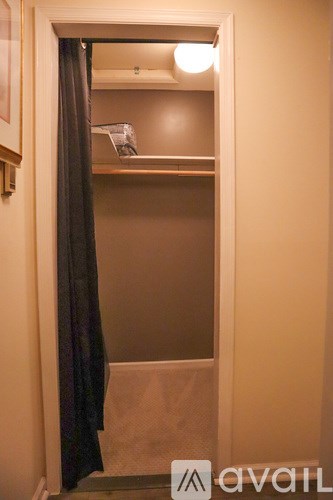 A kitchen with a sink, a stove, and a light hanging from the ceiling.