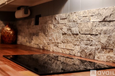 A bathroom with a toilet, sink, and mirror.