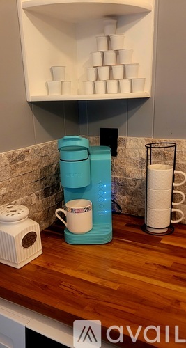 A small, empty kitchen with a refrigerator and a cabinet.