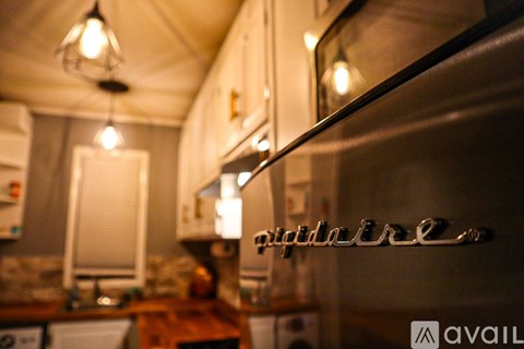 Levitt Pavilion is a white building with a stage and a large tent.