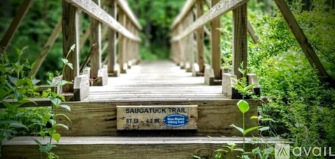 A beachfront area with a baseball field and parking lot.