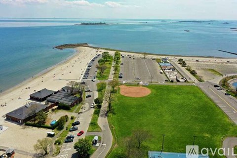A beachfront area with a baseball field and parking lot.