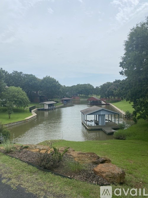 A body of water with a dock and a house in the distance.