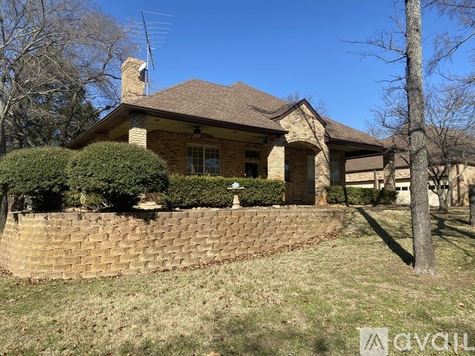 A house with a brown roof and a brick wall.