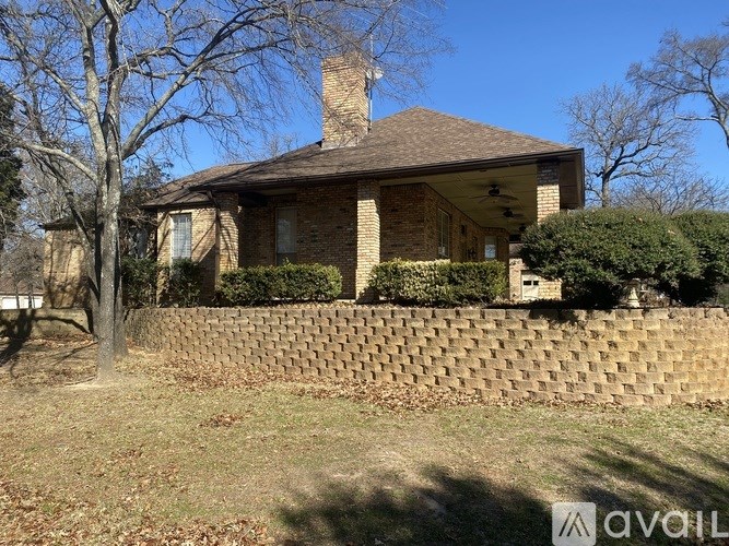 A house with a brick wall in front of it.