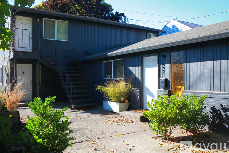 A house with a blue exterior and a white door is shown.