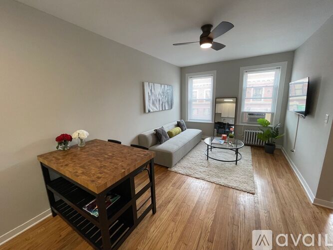 A living room with a wooden table and a couch.
