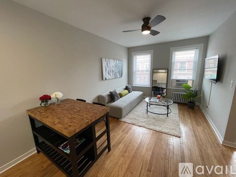 A living room with a wooden table and a couch.