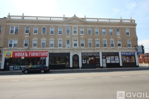 A building with a sign that says "Hogan Furniture" on the front.