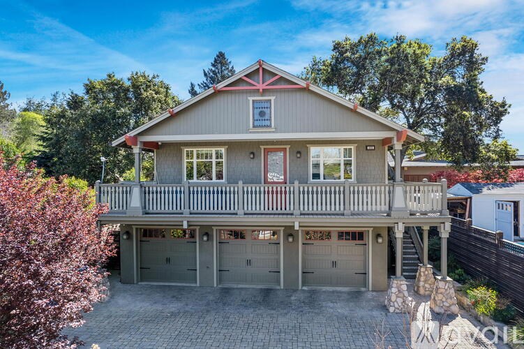 A house with a red roof and a balcony.