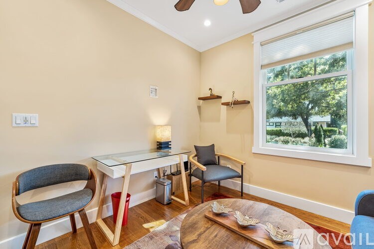 A living room with a white table and chairs.