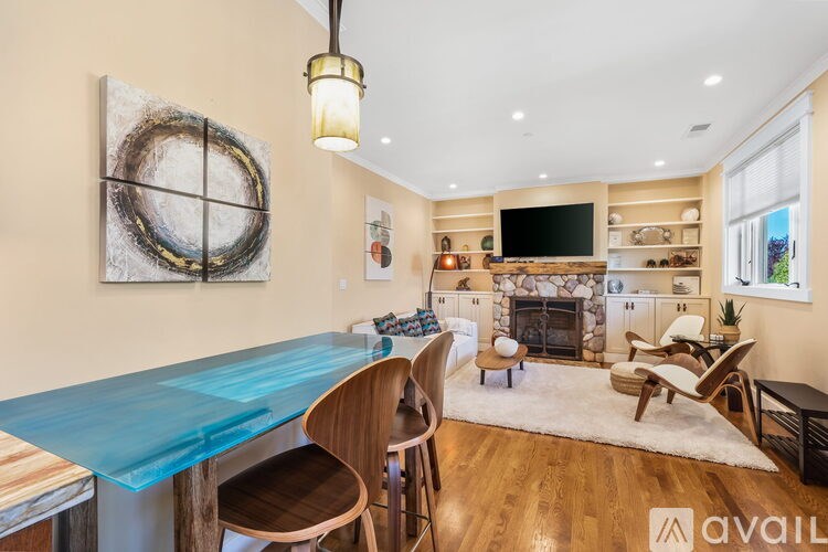 A modern dining room with a blue table and wooden chairs.