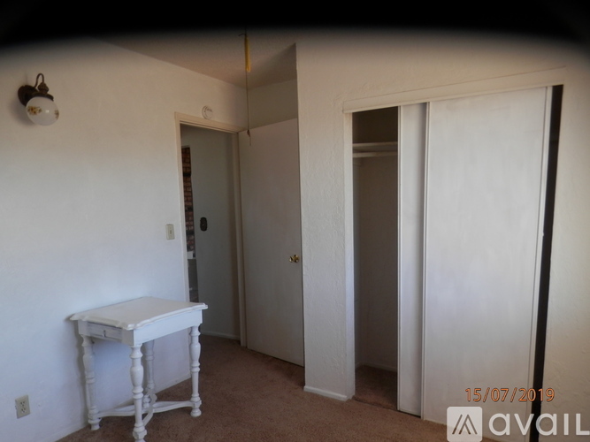 A room with a white table and a door.