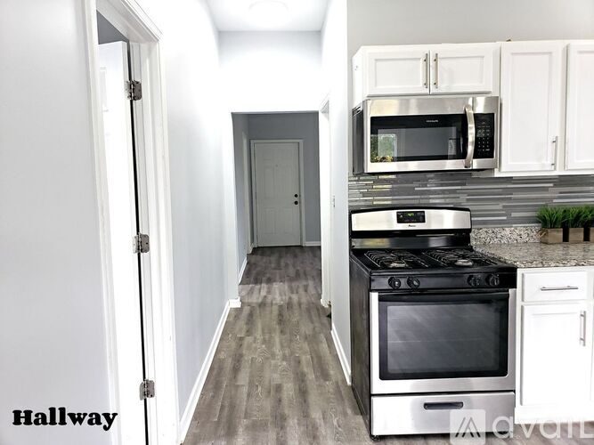 A kitchen with a stove, oven, and microwave.
