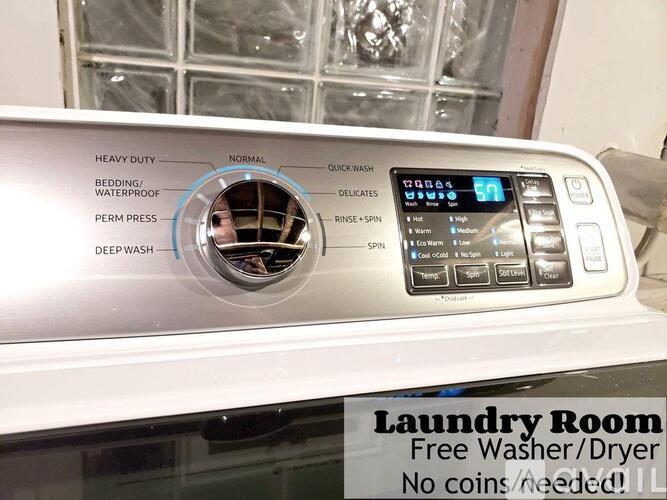 A front view of a washer and dryer with the text "Laundry Room Free Washer/Dryer No coins needed!!"
