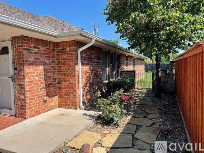 A house with a brick exterior and a stone pathway leading to the front door.