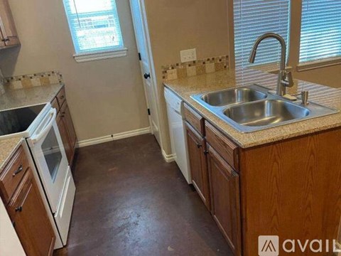 A kitchen with a sink and a window.