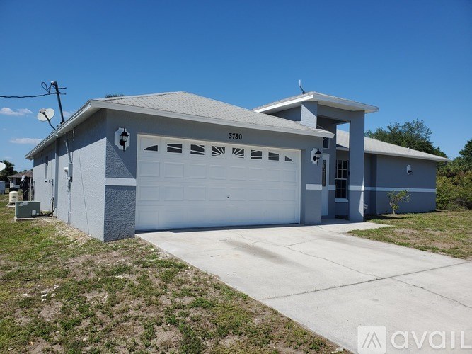 A two-story garage with a white door and windows on the side.
