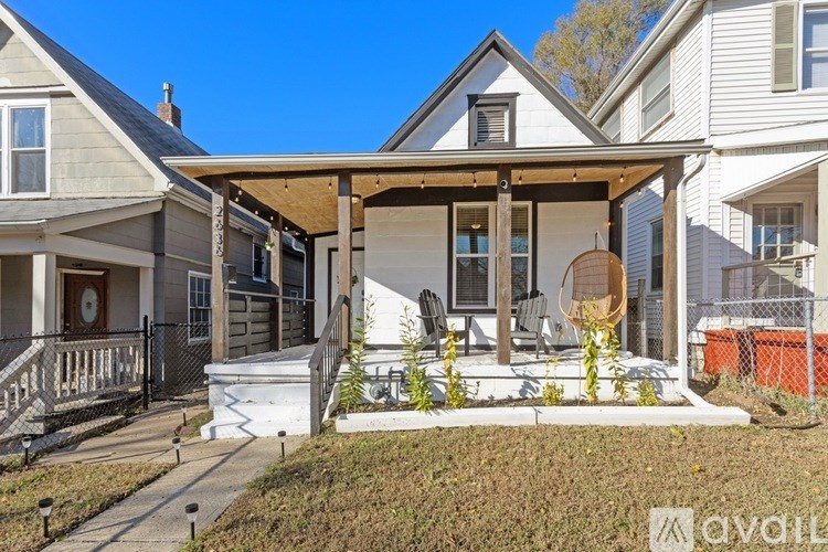 A house with a covered patio and a fence.