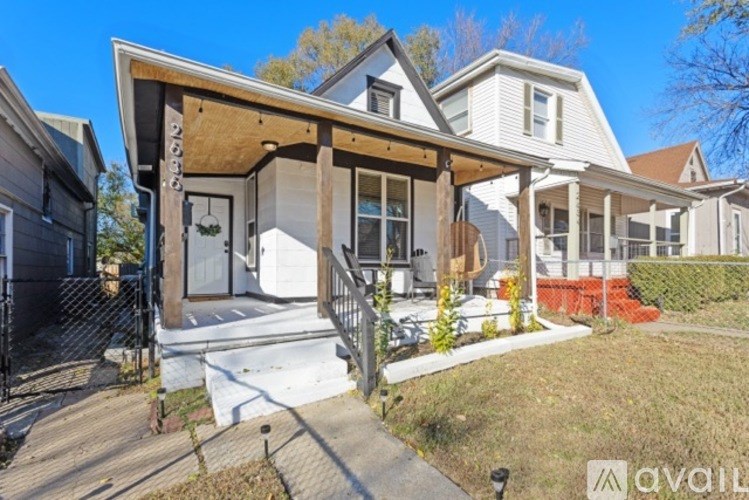 A house with a porch and a garage door.