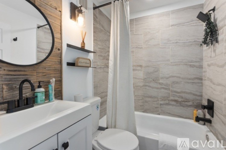 A bathroom with a white sink, toilet, and bathtub.