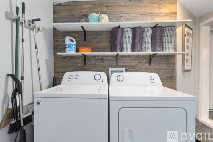 Two front loading washing machines in a laundry room.