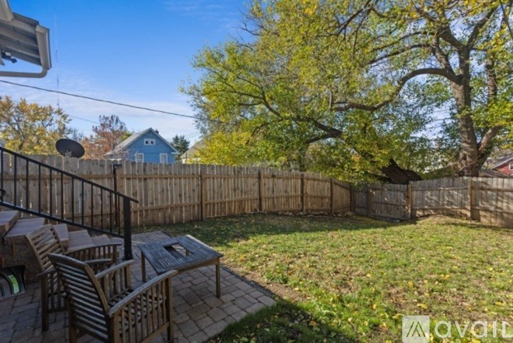 A backyard with a wooden deck and a fence.