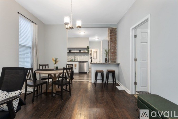 A dining room with a table set for four.
