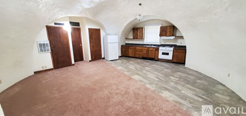 A kitchen area with a refrigerator, sink, and cabinets is available for rent.