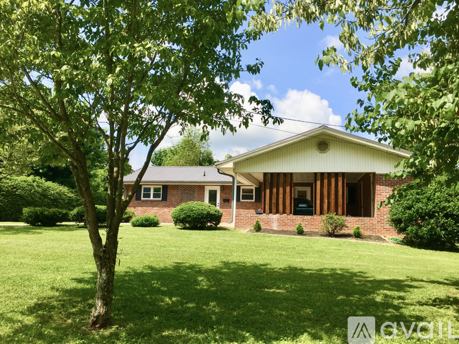 A house with a tree in front of it.