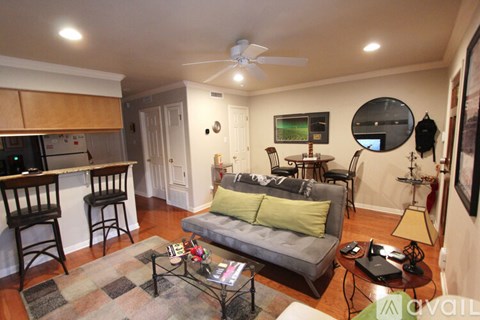 A living room with a grey couch and a coffee table.