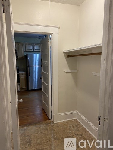A kitchen with a refrigerator and a pantry.